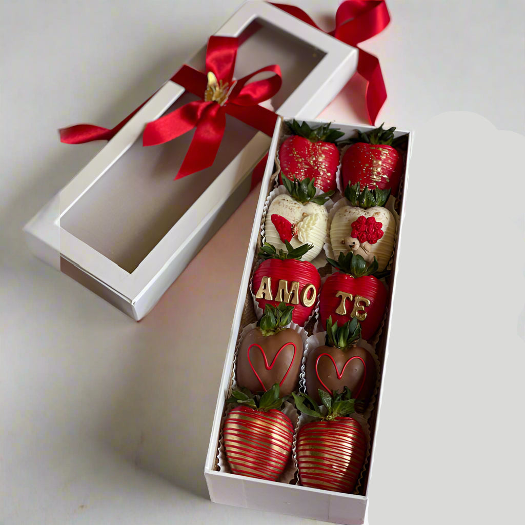 Box of decorated strawberries with red and white ribbons on a light background