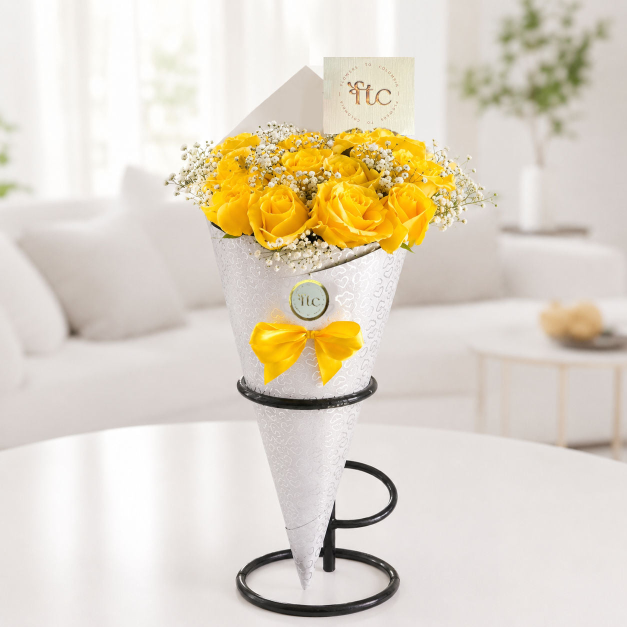 Elegant cone bouquet with 12 premium yellow roses and baby's breath in luxury white wrapping for same-day flower delivery in Restrepo, Meta.