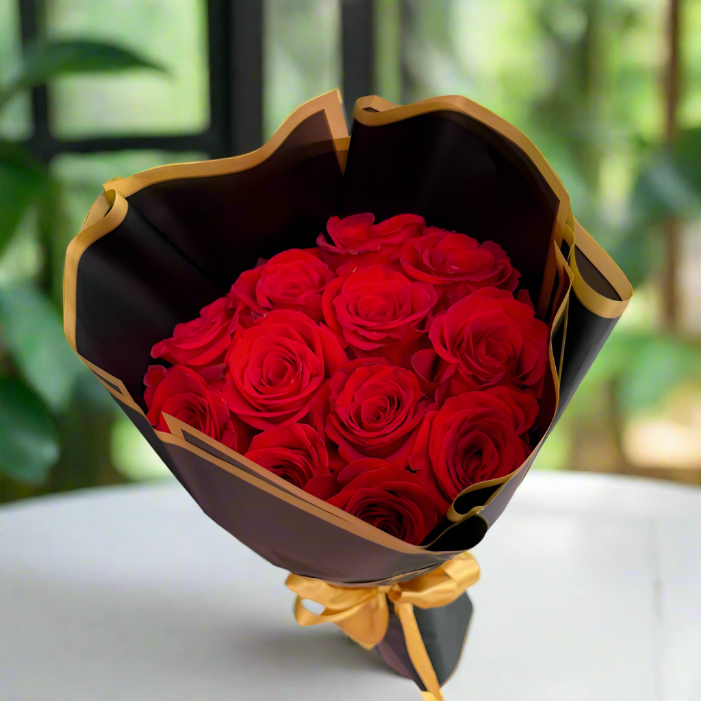 Bouquet of 12 red roses wrapped in elegant black Korean paper with golden edge
