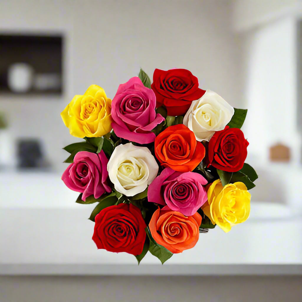 Bouquet of colorful roses on a light surface with a neutral background