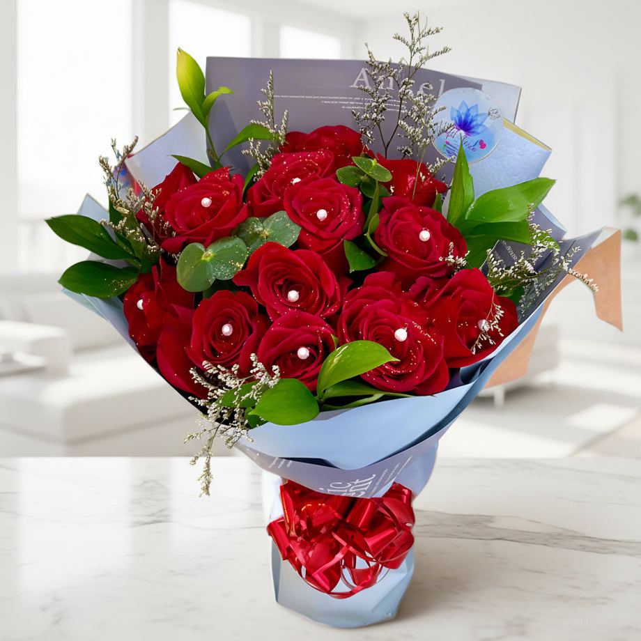 Bouquet of 14 red roses with pearl accents and greenery in Korean paper – delivery in Arboletes, Antioquia