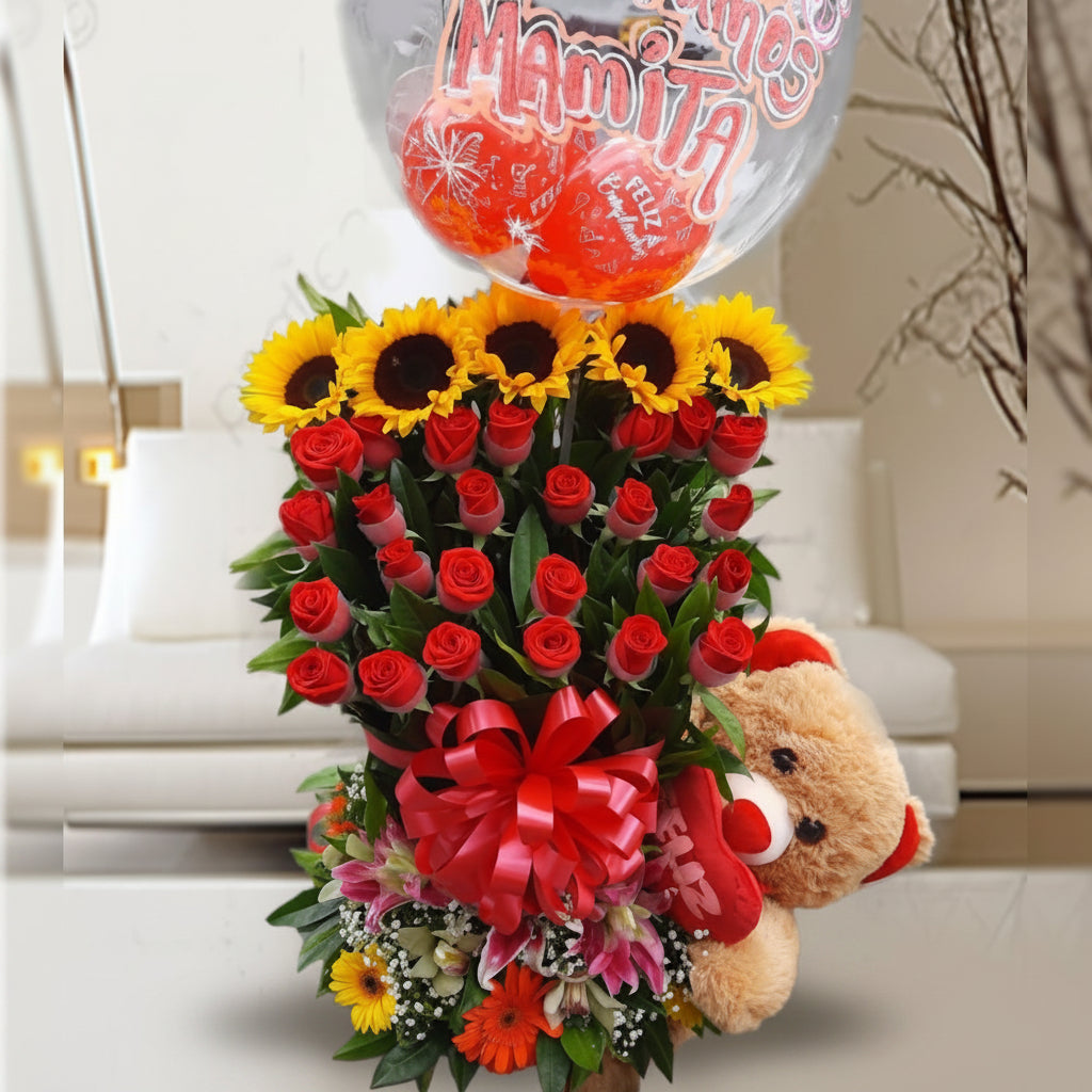 Arrangement of 24 red roses, sunflowers, gerberas, lilies with teddy bear and "Te amamos mamita" balloon, special for Mom
