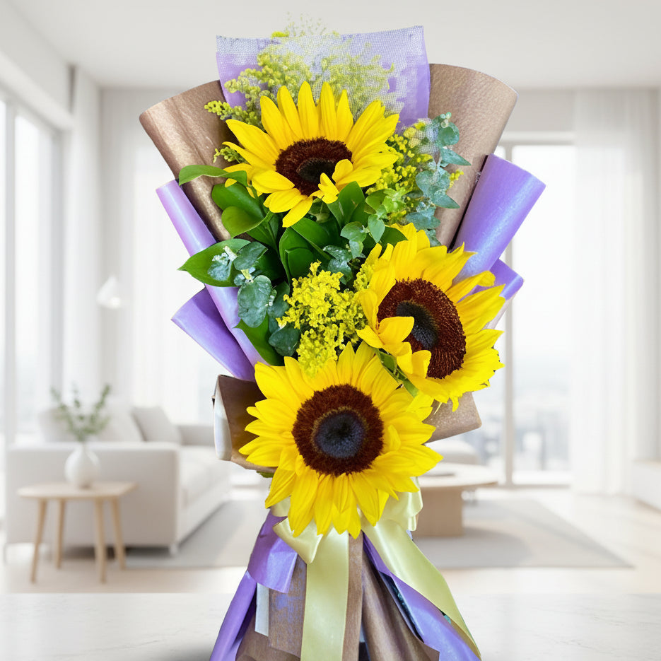 Bouquet of 3 sunflowers with greenery in purple and kraft Korean paper wrap with yellow ribbon – delivery in Arboletes, Antioquia