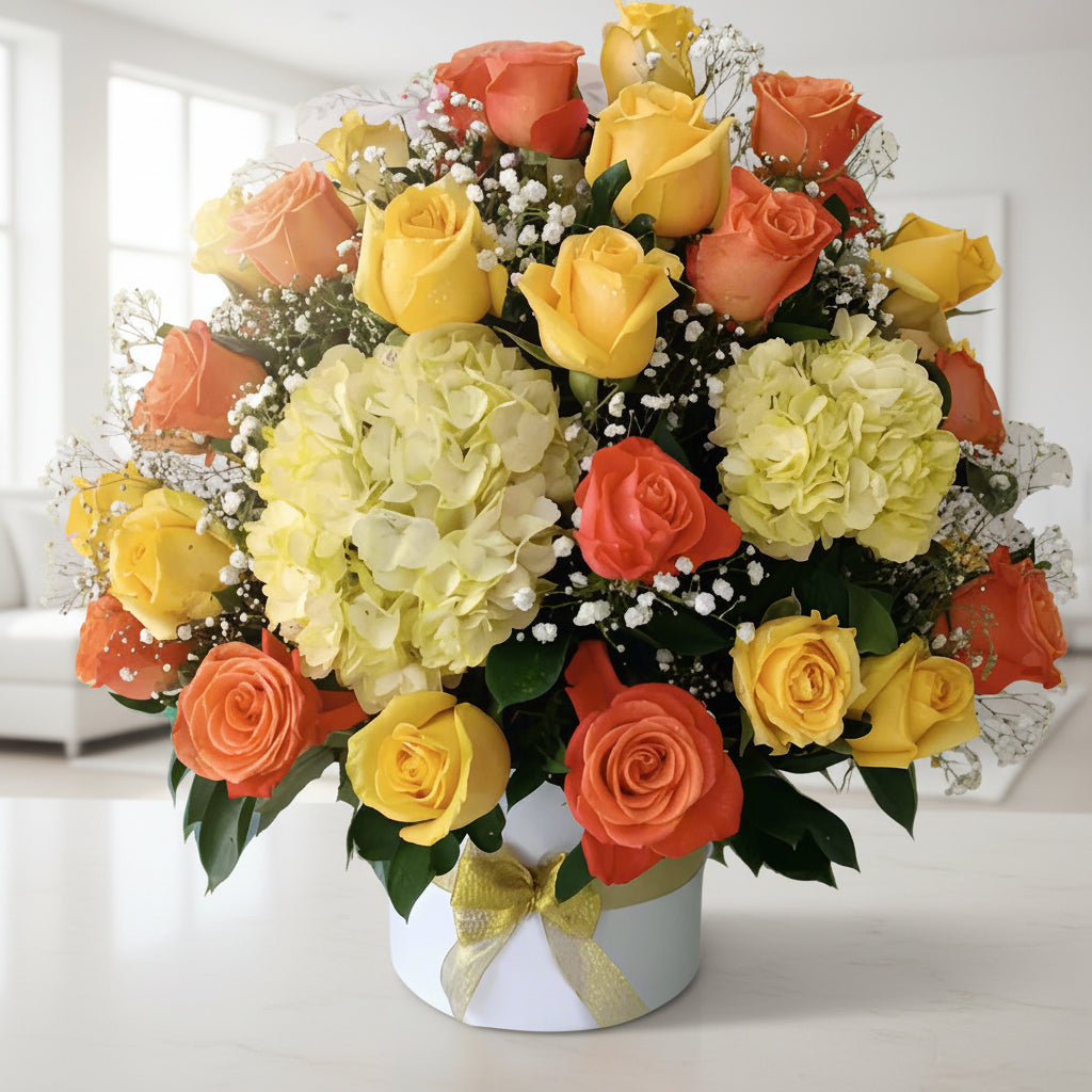 Arrangement of 50 yellow and orange roses with hydrangeas in a box, available for delivery in Bogotá, Medellín, Cúcuta, Pereira, and Cali