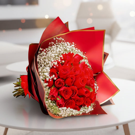 Bouquet of 36 premium red roses with gypsophila, wrapped in luxurious imported paper and tied with a red ribbon, perfect for Valentine’s Day in Medellín.