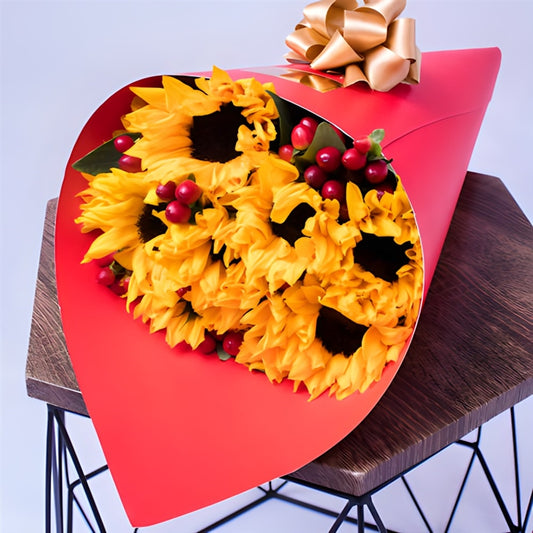 Bouquet with seven sunflowers and red foliage – delivery available across Colombia