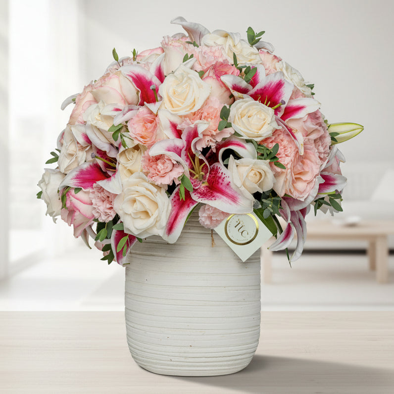 Elegant pastel flower arrangement with roses, hydrangeas and orchids in white vase Medellín Colombia delivery