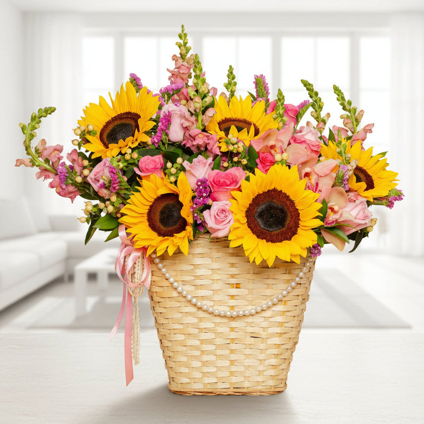 Mother’s Day flower basket with sunflowers, roses, and seasonal blooms in a woven basket with pearl details – Medellín delivery