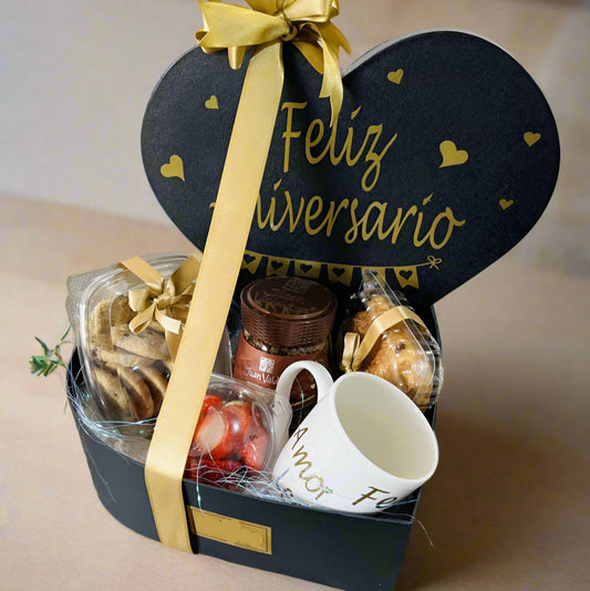 Elegant black and gold heart-shaped anniversary gift box with coffee, cookies, chocolates, and a mug – perfect for men, available in Medellín.
