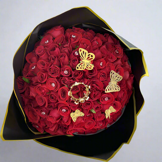 Bouquet of 100 red roses decorated with rhinestones, butterflies, and a crown, wrapped in imported black paper