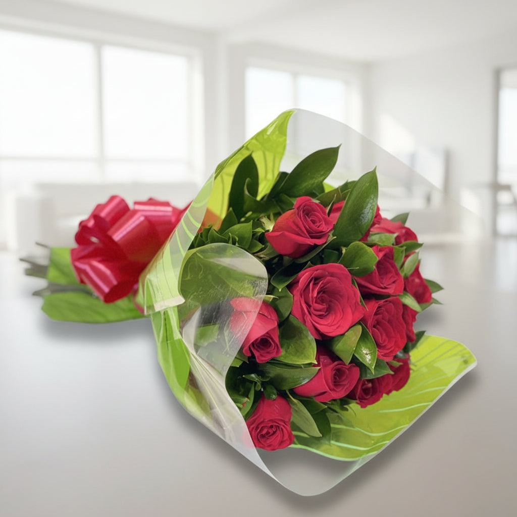 Bouquet of 12 red roses wrapped in paper with ribbon, available for delivery in all cities of Colombia