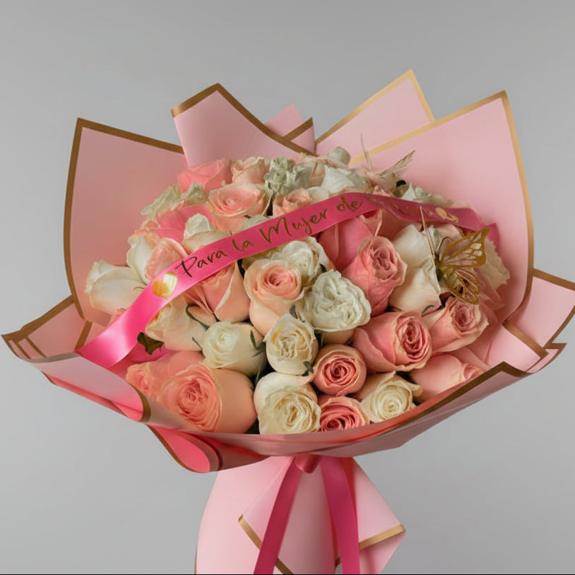 Bouquet of pink and white roses with a pink ribbon on a light gray background