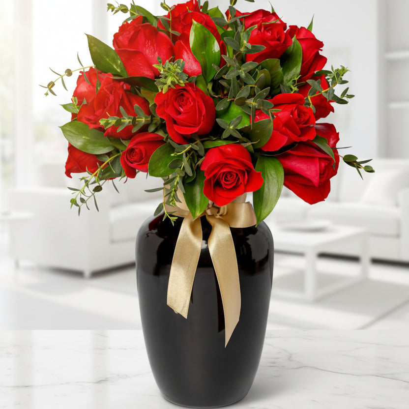 Luxury black vase with 36 red roses and seasonal foliage, available for delivery in Medellín and Bogotá