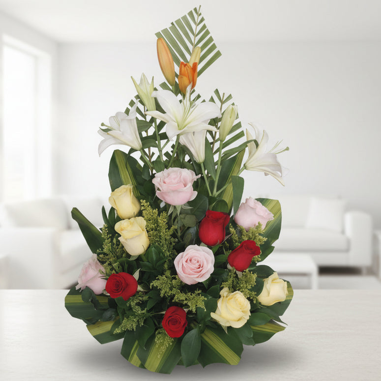 Elegant floral arrangement with white lilies and mixed roses in red, pink, and yellow tones, ideal for flower delivery in Bucaramanga, Colombia.