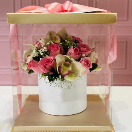 Luxury orchid and pink rose arrangement in a premium box with transparent packaging – Medellín flower delivery