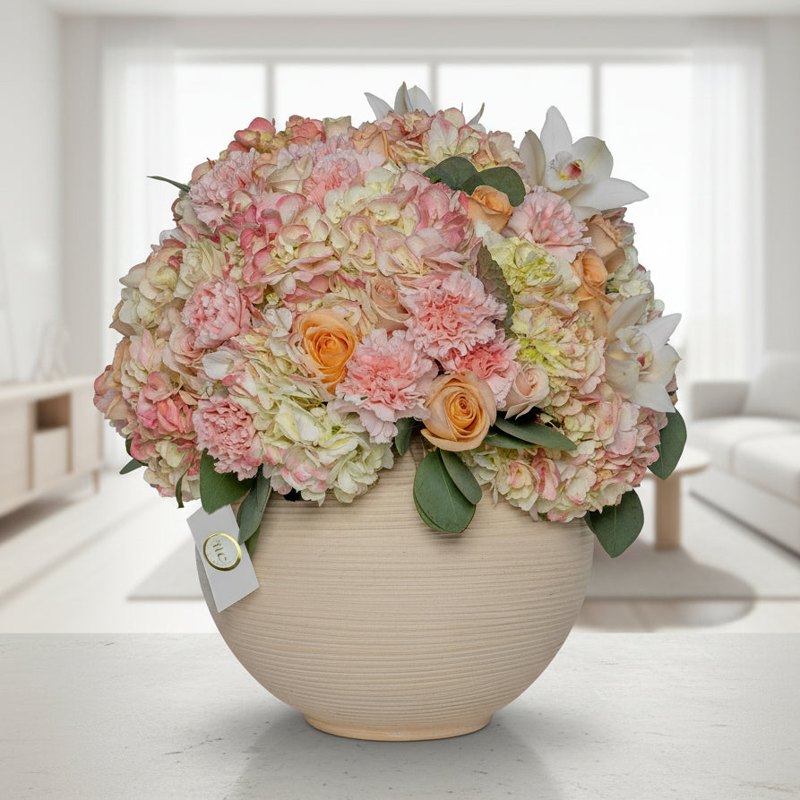 Elegant pastel flower arrangement with hydrangeas, roses and orchids in ceramic vase Medellín Colombia same day delivery