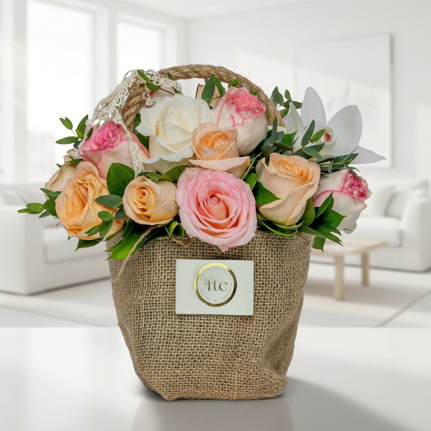Pastel rose basket with cymbidium orchid and greenery Medellín Colombia flower delivery