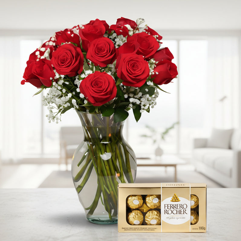 Red roses arrangement in glass vase with Ferrero Rocher chocolates, elegant flower delivery in Medellín.