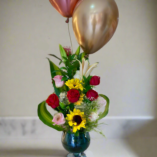 Glass vase with 11 roses, lilies, sunflowers, and greenery – flower arrangement for delivery in Arboletes, Antioquia