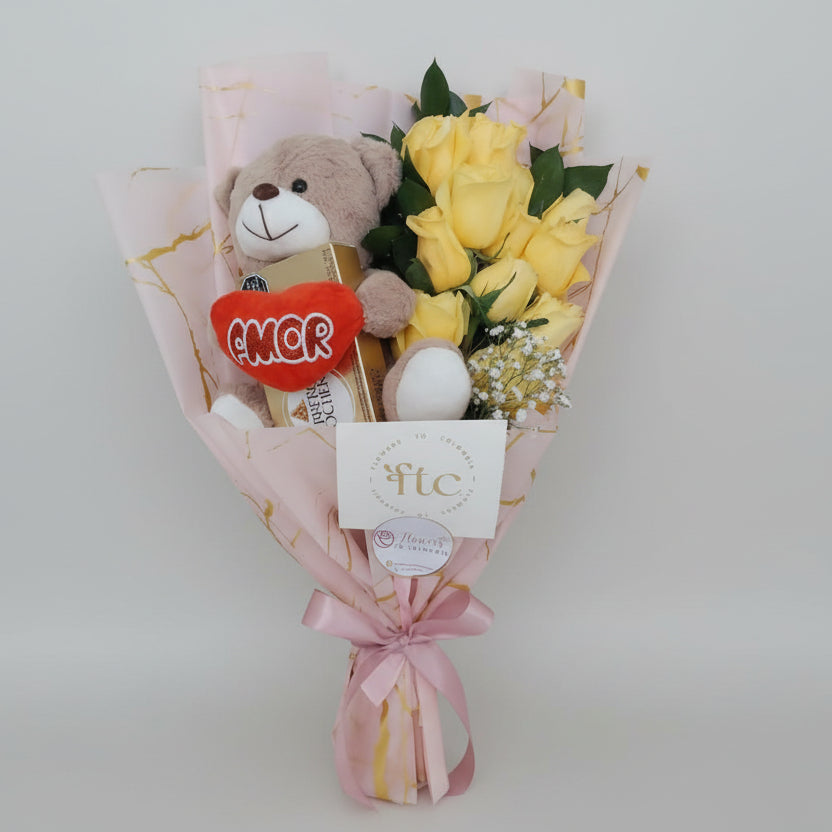 Romantic bouquet with yellow roses, a soft teddy bear, and chocolates, beautifully wrapped and ideal for flower delivery in Bucaramanga, Colombia.
