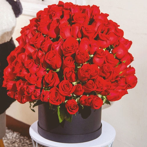 120 red roses beautifully arranged in a box, available for delivery in Medellín