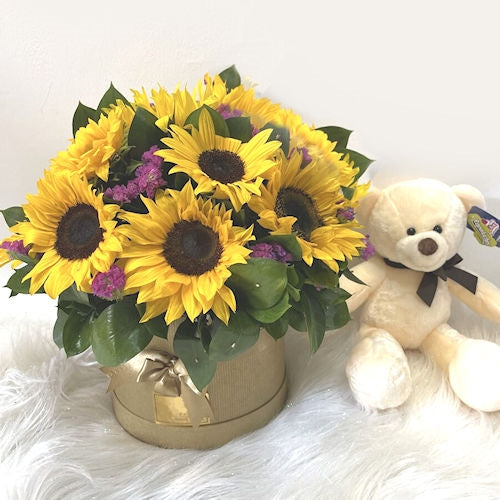 Sunflowers in box with teddy bear