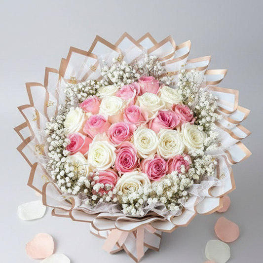 Elegant bouquet of 25 roses in soft pink and white tones, accented with baby’s breath and wrapped in layered white and beige floral paper, available for delivery in Medellín, Colombia.