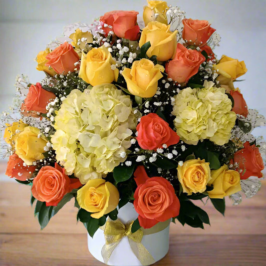 Arrangement of 50 yellow and orange roses with hydrangeas in a box, available for delivery in Bogotá, Medellín, Cúcuta, Pereira, and Cali