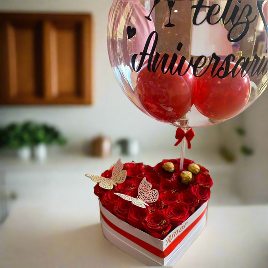 Heart-shaped box with red roses, Ferrero chocolates, butterflies, and “Happy Anniversary” balloon – Acacías, Meta