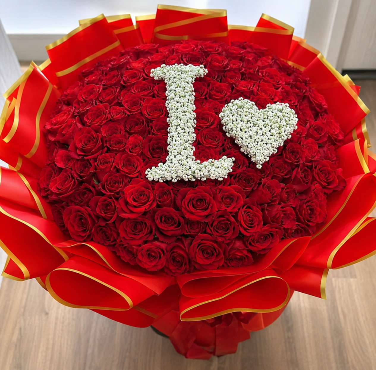Bouquet of red roses with 'I love' message on a wooden surface