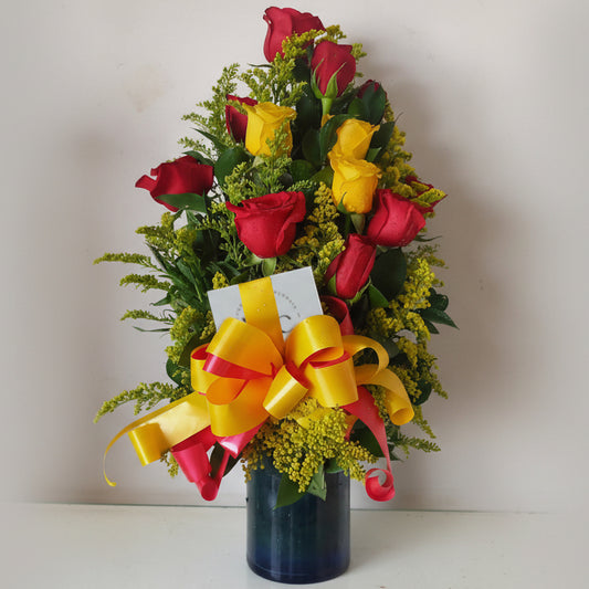 Red and yellow rose arrangement in glass vase for delivery in Cartagena, Colombia