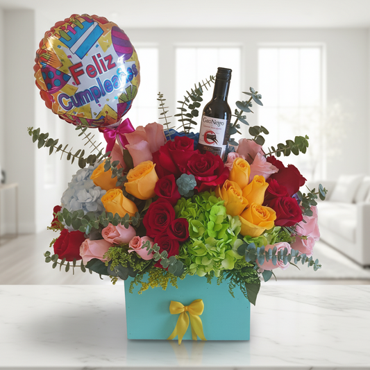 birthday flower arrangement with mixed roses hydrangea wine bottle and balloon for delivery in Cali Colombia