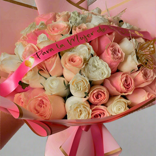 Bouquet of pink and white roses with a pink ribbon on a light gray background