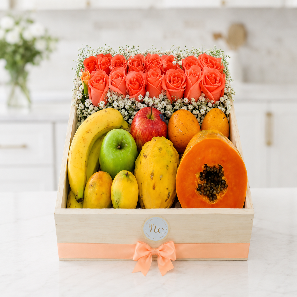 Luxury wooden gift box with fresh tropical fruits, premium coral roses, and baby's breath for same-day gift delivery in Restrepo, Meta.