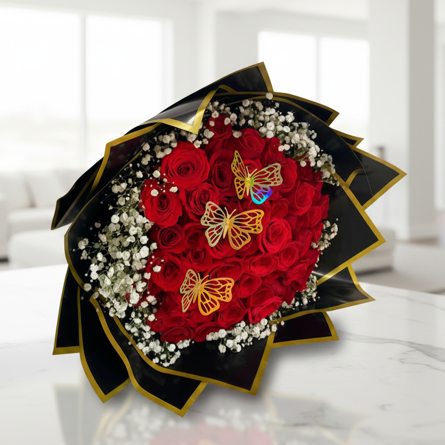 Heart-shaped bouquet of red roses decorated with baby’s breath and golden butterfly accents, ideal for romantic flower delivery in Bucaramanga, Colombia.