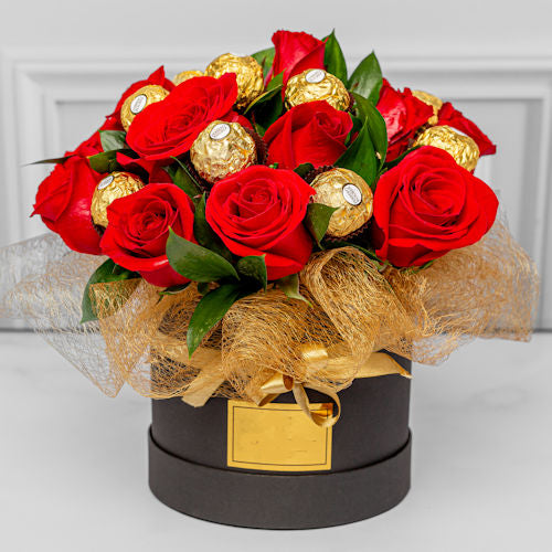 Luxury floral arrangement with red roses and Ferrero chocolates, available for delivery in Medellín and Bogotá