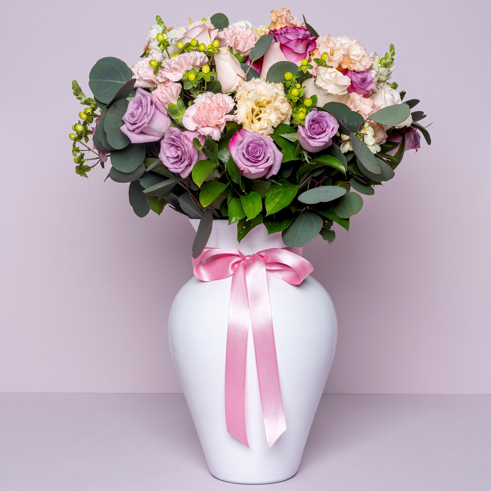 Modern pastel rose bouquet with green anthurium and seasonal flowers wrapped in premium paper in Medellín