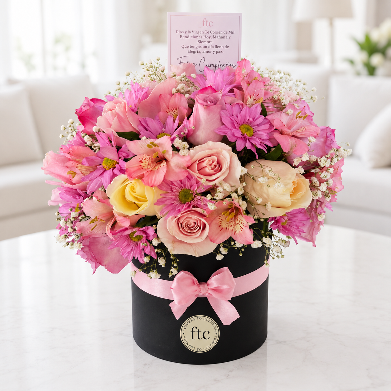 Luxury black hat box with pink roses, pink daisies, alstroemeria, baby's breath, and mixed fresh flowers for same-day flower delivery in Restrepo, Meta.