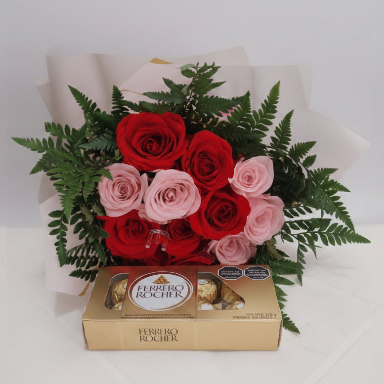Elegant bouquet of red and pink roses with lush greenery, paired with Ferrero Rocher chocolates, ideal for flower delivery in Bucaramanga, Colombia.