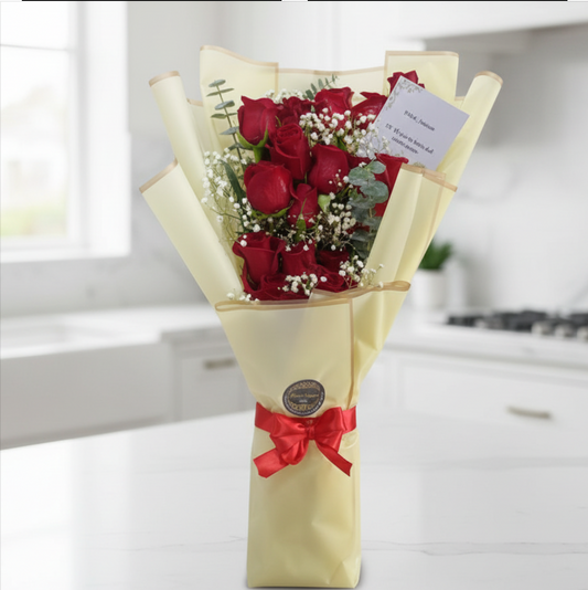 Elegant bouquet of 12 premium red roses with baby's breath, eucalyptus, and luxury ivory wrapping for same-day flower delivery in Restrepo, Meta.