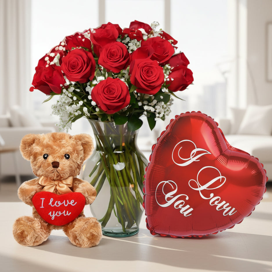 Red roses arrangement in glass vase with teddy bear and “I Love You” heart balloon, romantic flower delivery in Medellín.