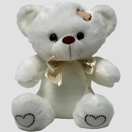 10-inch Teddy Bear with flowers, available for delivery across Colombia