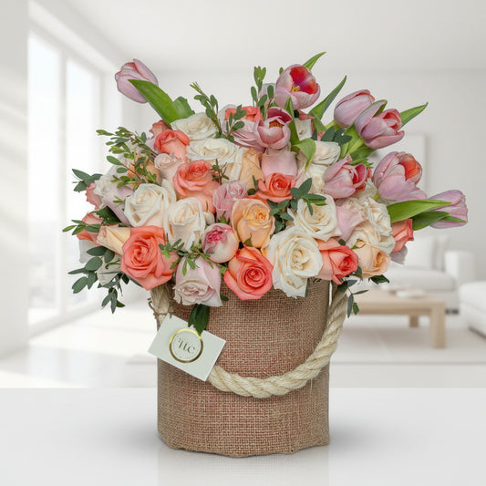 Warm rose and tulip basket arrangement with greenery Medellín Colombia flower delivery same day